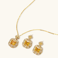 14K gold-plated jewelry set featuring square-cut cubic zirconia stones in ornate layered settings on white background.