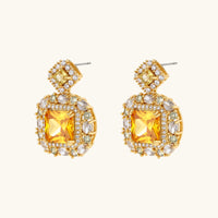 14K gold-plated jewelry set featuring square-cut cubic zirconia stones in ornate layered settings on white background.