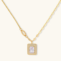 Gold-plated jewelry set with rectangular cubic zirconia stones in pave halo settings on cream background