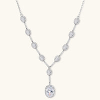 Elegant white gold plated jewelry set with oval cubic zirconia stones in halo settings, featuring Y-necklace and drop earrings.