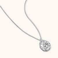 Sterling silver necklace featuring a large pear-shaped moissanite stone in an ornate setting with smaller accent stones