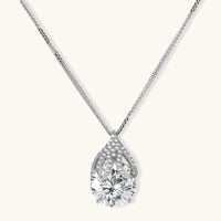 Sterling silver necklace featuring a large pear-shaped moissanite stone in an ornate setting with smaller accent stones