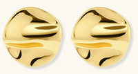 Close-up of organic gold-plated sterling silver stud earrings with flowing sculptural design and curved cut-outs