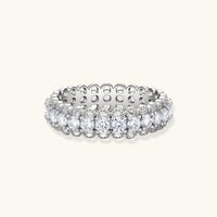 Sterling silver eternity ring with continuous row of brilliant moissanite stones in scalloped crown setting with milgrain detail