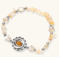 Complete jewelry set featuring citrine stone chips, silver beads, and cosmic circle pendants on cream background.