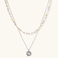 Complete jewelry set featuring citrine stone chips, silver beads, and cosmic circle pendants on cream background.