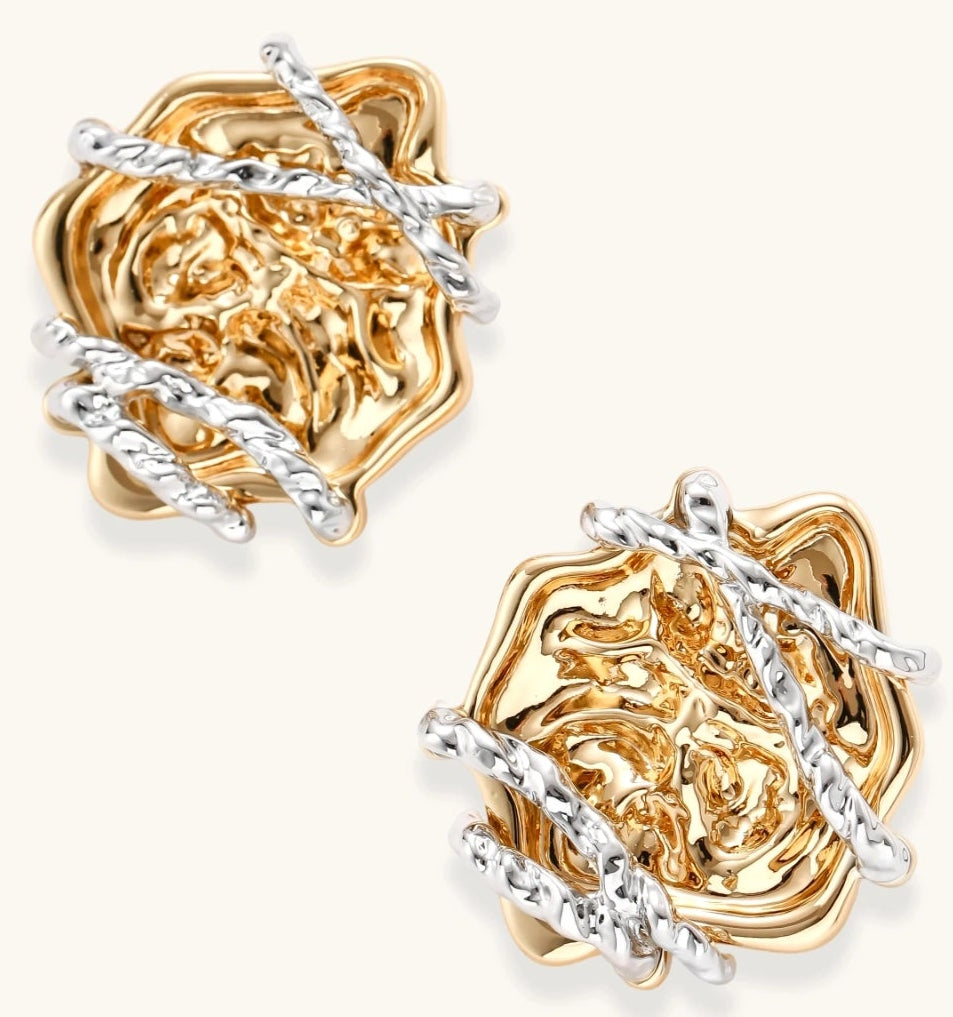 Sculptural rose-shaped stud earrings in gold with silver wire details and S925 posts on cream background.
