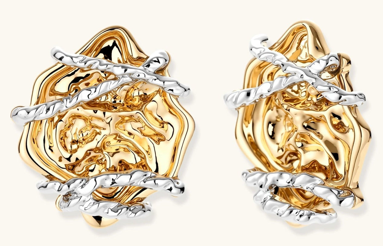 Sculptural rose-shaped stud earrings in gold with silver wire details and S925 posts on cream background.