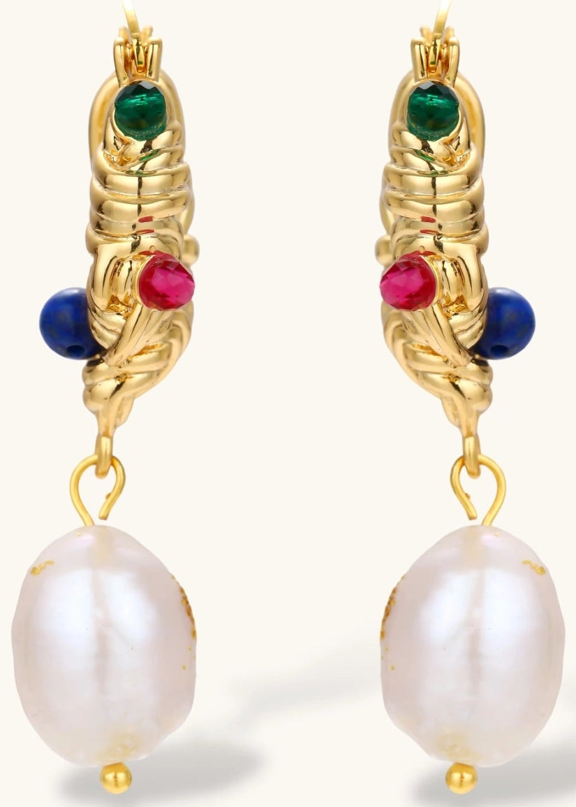 Ornate gold-plated hoop earrings with emerald, ruby, and sapphire accents, featuring dangling baroque freshwater pearls