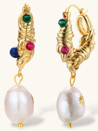 Ornate gold-plated hoop earrings with emerald, ruby, and sapphire accents, featuring dangling baroque freshwater pearls