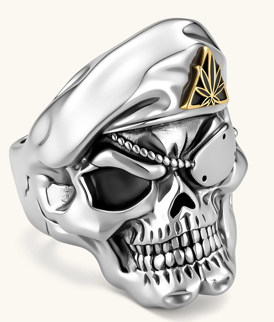 925 sterling silver skull ring wearing a military beret with a gold triangular cannabis leaf badge, blackened eye sockets, 23.9g.