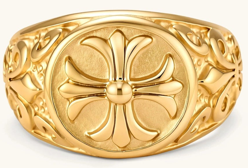 18K gold-plated stainless steel signet ring with ornate cross face and carved filigree scroll band, shown from three angles.