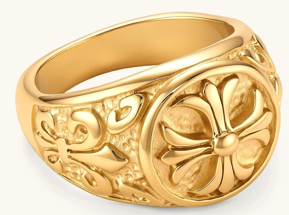 18K gold-plated stainless steel signet ring with ornate cross face and carved filigree scroll band, shown from three angles.
