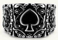 Silver-tone 316L stainless steel signet ring with black enamel spade motif and intricate floral scrollwork relief detail.