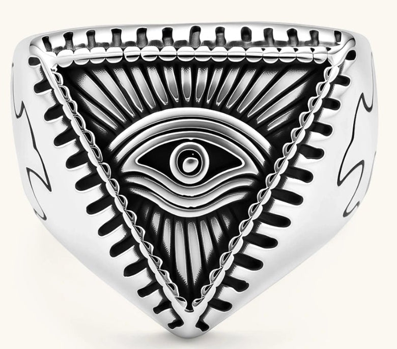 Silver stainless steel signet ring with engraved all-seeing eye in triangle, radiating lines, and cross motifs on the band.
