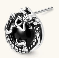 Silver stainless steel stud earring with coiled dragon motif wrapped around a black stone, shown from front and side.