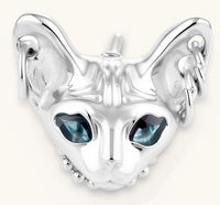 3D sculpted stainless steel Sphynx cat head stud earring with blue CZ eyes and hoop ear details, silver finish.