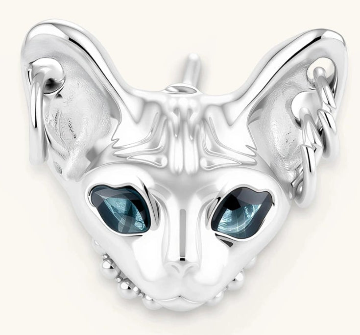 3D sculpted stainless steel Sphynx cat head stud earring with blue CZ eyes and hoop ear details, silver finish.
