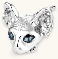 3D sculpted stainless steel Sphynx cat head stud earring with blue CZ eyes and hoop ear details, silver finish.