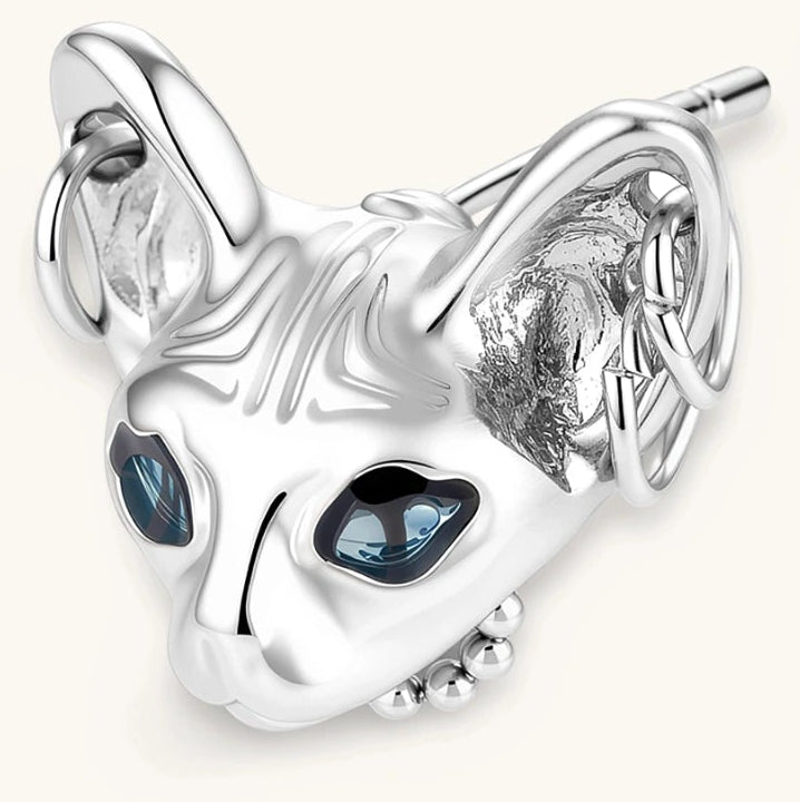 3D sculpted stainless steel Sphynx cat head stud earring with blue CZ eyes and hoop ear details, silver finish.