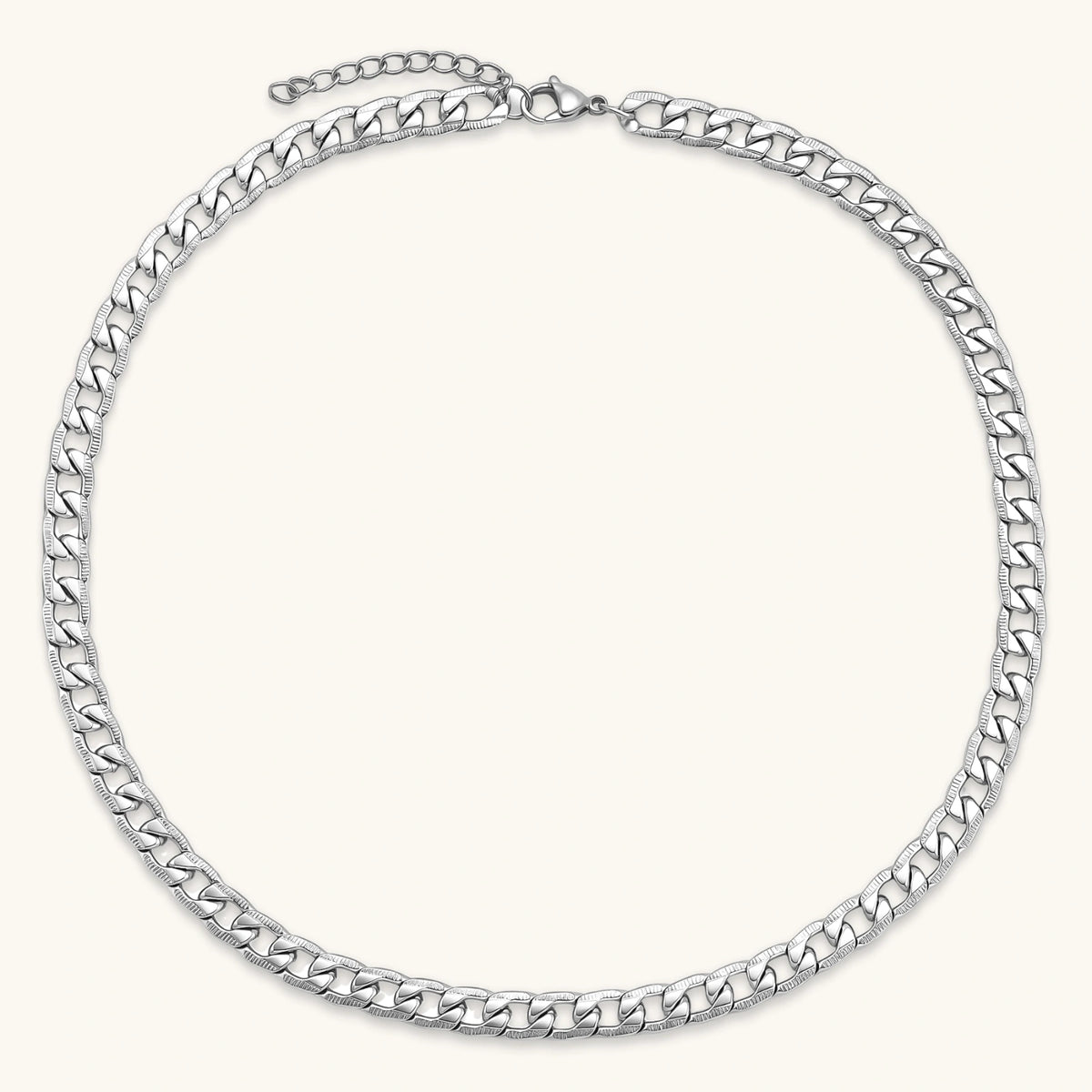 Silver 316L stainless steel carved curb chain necklace with lobster clasp and extender, 7.2mm wide, on cream background.
