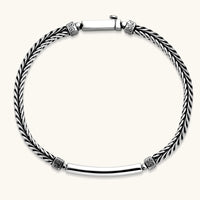 Silver stainless steel men's bracelet with braided foxtail chain, Greek key engraved bar, and decorative cube connectors.