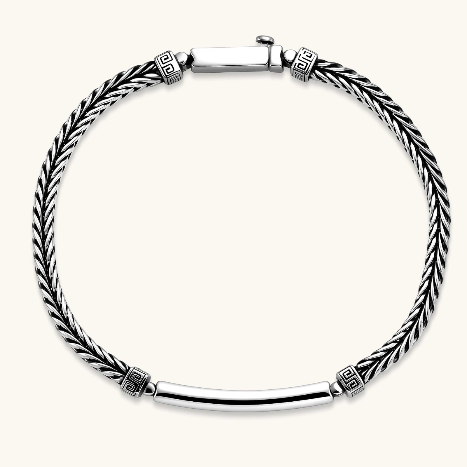 Silver stainless steel men's bracelet with braided foxtail chain, Greek key engraved bar, and decorative cube connectors.