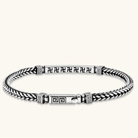 Silver stainless steel men's bracelet with braided foxtail chain, Greek key engraved bar, and decorative cube connectors.
