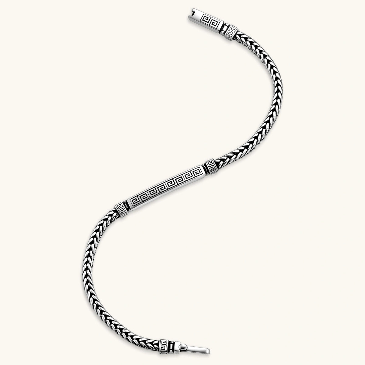 Silver stainless steel men's bracelet with braided foxtail chain, Greek key engraved bar, and decorative cube connectors.