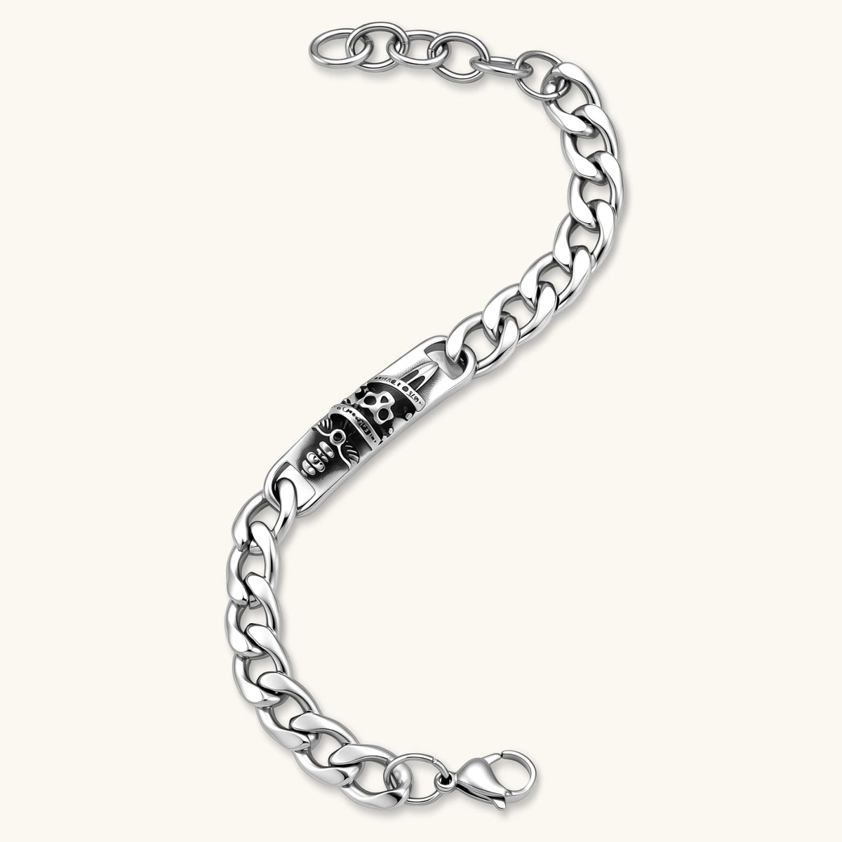 Silver 316L stainless steel Cuban chain bracelet with blackened skull and crown ID bar centerpiece, lobster clasp closure.