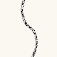 Men's antique silver Byzantine chain necklace, 6.2mm wide interlocking S-link pattern with ornate lobster clasp, 560mm length.