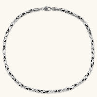 Men's antique silver Byzantine chain necklace, 6.2mm wide interlocking S-link pattern with ornate lobster clasp, 560mm length.