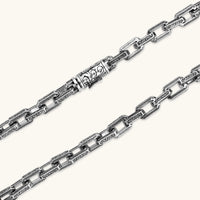 Silver 316L stainless steel rectangular link chain necklace with intricate scroll engravings, 560mm length, 7.1mm width.