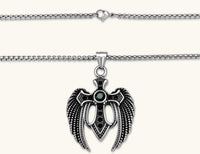 Silver stainless steel angel wing cross pendant necklace with green CZ center stone and black crystals on a box chain.