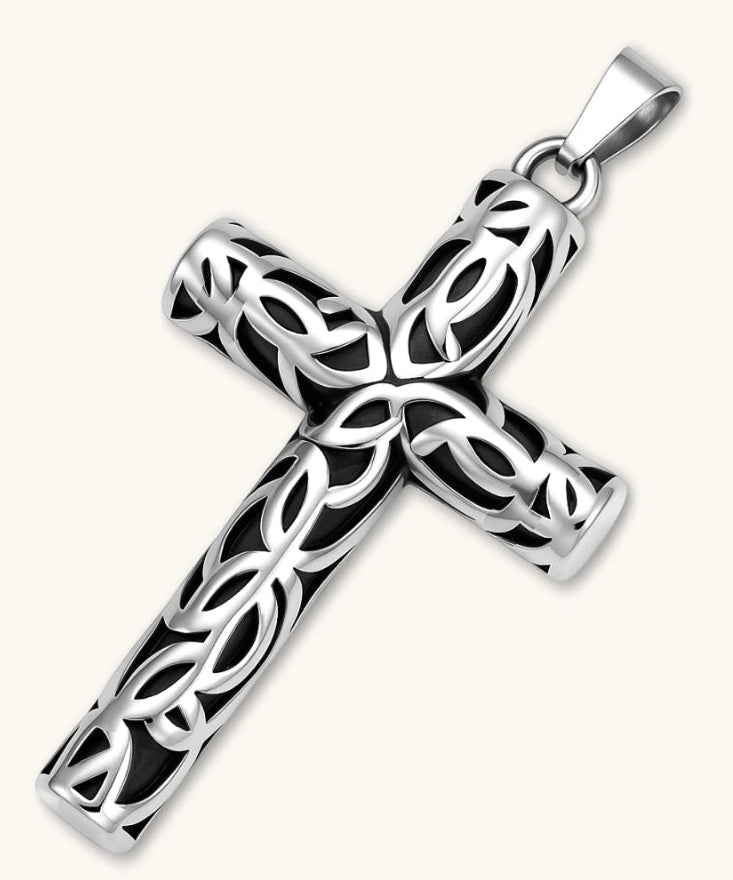 Silver stainless steel Celtic cross pendant with filigree vine pattern on a box chain, against a cream background.