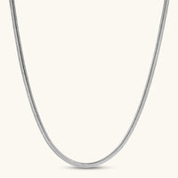 Two-tone twisted necklace with interlocked gold and silver ribbed snake chains, 6mm wide, on a white background.