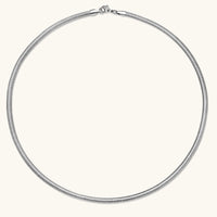 Two-tone twisted necklace with interlocked gold and silver ribbed snake chains, 6mm wide, on a white background.