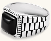 Silver stainless steel signet ring with checkered band texture, beaded border, and square black onyx cabochon stone center.