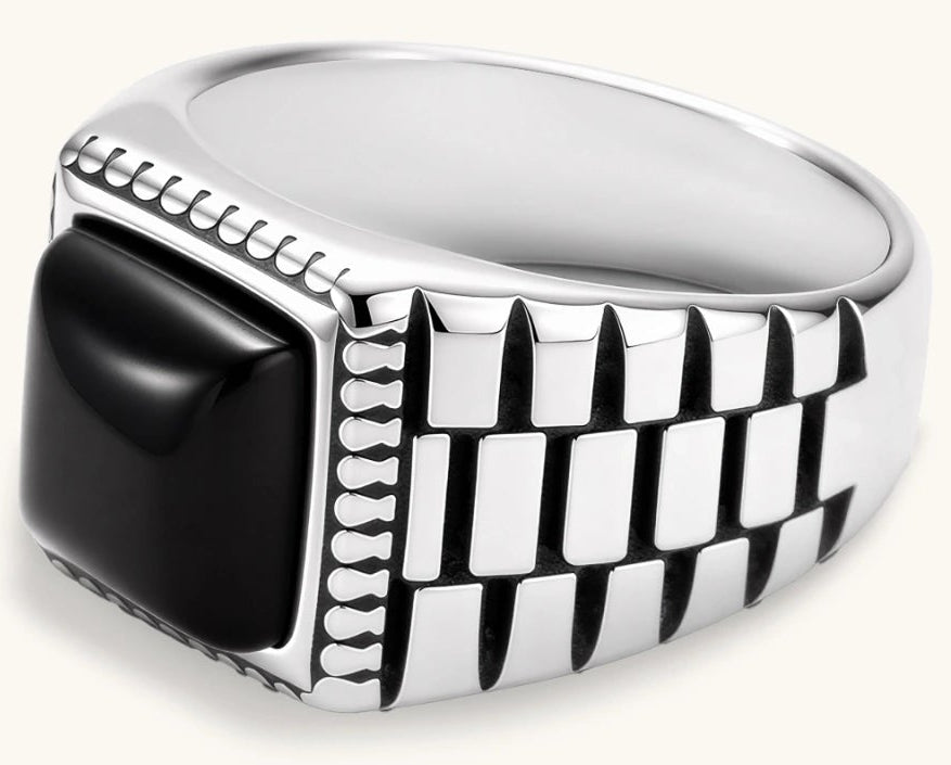 Silver stainless steel signet ring with checkered band texture, beaded border, and square black onyx cabochon stone center.