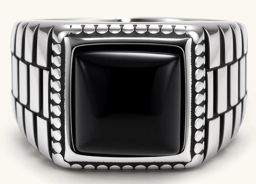 Silver stainless steel signet ring with checkered band texture, beaded border, and square black onyx cabochon stone center.