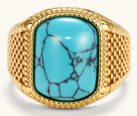 Gold PVD stainless steel signet ring with cushion faux turquoise stone and textured honeycomb band, front view.
