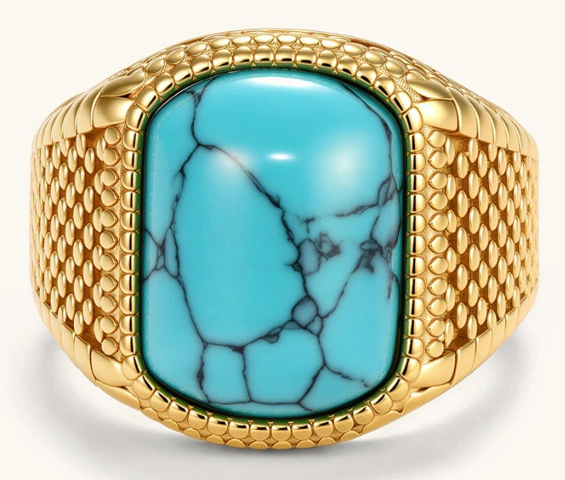 Gold PVD stainless steel signet ring with cushion faux turquoise stone and textured honeycomb band, front view.