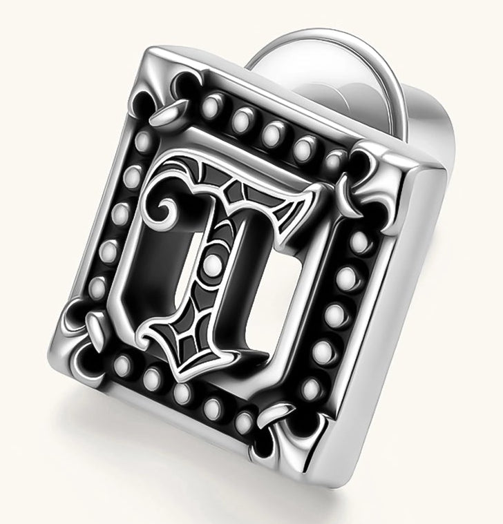 Square 925 sterling silver stud earring with oxidized Gothic letter, ornate dot border, fleur-de-lis corners, butterfly back.