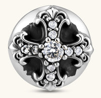 Sterling silver dome stud earring with oxidized black petals, ornate scrollwork, and clear cubic zirconia stones, butterfly back.