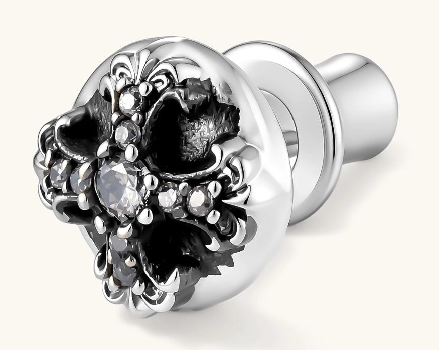 Sterling silver dome stud earring with oxidized black petals, ornate scrollwork, and clear cubic zirconia stones, butterfly back.